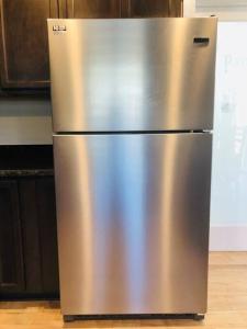 a stainless steel refrigerator sitting in a kitchen at Riverside Cabin 6 in Grants Pass