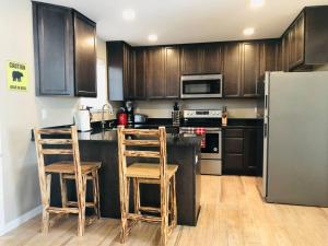 a kitchen with wooden cabinets and stainless steel appliances at Riverside Cabin 6 in Grants Pass