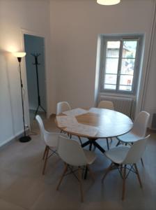 a dining room with a table and white chairs at O'Couvent - Appartement 441 - 3 chambres - 97 m2 - Quatrième étage in Salins-les-Bains