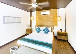 a bedroom with a bed and a ceiling fan at Cadlao Resort and Restaurant in El Nido