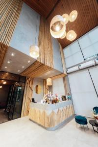 a lobby with a reception desk in a building at Phu sakon ville hotel in Ban Phang Khwang Tai