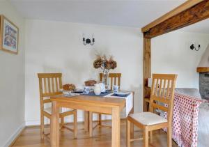 a dining room with a wooden table and chairs at Felin Fach in Pumpsaint