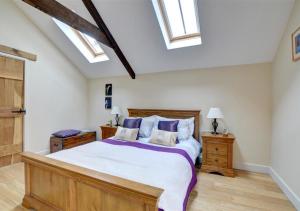 a bedroom with a large bed and skylights at Felin Fach in Pumpsaint