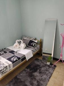 a bedroom with a bed with a mirror and a rug at Home in San Pablo city, Laguna in San Pablo