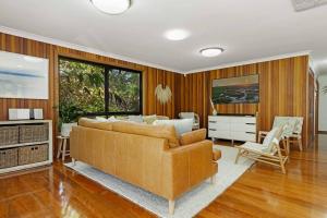 a living room with a couch and a bedroom at 20 Steps - Beachfront Home - Stunning & Stylish - North of Byron in New Brighton