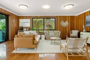 a living room with a couch and a table at 20 Steps - Beachfront Home - Stunning & Stylish - North of Byron in New Brighton