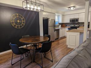 a kitchen and living room with a table and chairs at Adorable 4 bed,3 bath house in Kingston