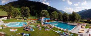 a group of people sitting around a water park at Appartements Hartlbauer in Dorfgastein