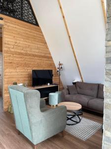 a living room with a couch and a table at Crna Ovca Lopatnica in Lopatnica