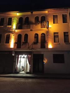 ein großes weißes Gebäude mit Balkon in der Nacht in der Unterkunft LUWİ ANTAKYA BOUTİQUE HOTEL in Hatay