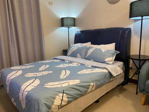 a bedroom with a bed with a blue headboard at Seaview Sunset Accommodation in Cebu City
