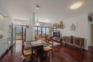 a kitchen and living room with a table and chairs at Funchal bay view Vista Mar I in Funchal