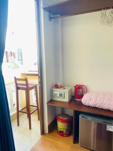 Zimmer mit einem Bett und einem Tisch mit einer Mikrowelle in der Unterkunft THE VIEW HOMESTAY HỘI AN in Hoi An