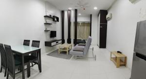 a living room with a table and chairs and a dining room at Shawn Akademic Suites Pool View @ Mount Austin in Johor Bahru
