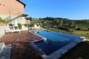 a swimming pool in the backyard of a house at B&B Tricudai in Agliano Terme