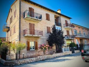 a large brick building with balconies on a street at B&B Iris in Assisi