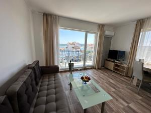 a living room with a couch and a table at Вила Quiet Bay in Sozopol
