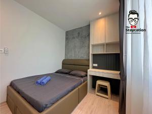 a small bedroom with a bed and a desk at Staycation Homestay 24 Royal Richmond Near Airport in Kuching