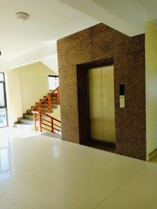 a hallway with a door in a building with stairs at Lai Dinh Hotel in Sầm Sơn