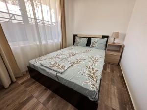 a small bedroom with a bed with a window at Вила Quiet Bay in Sozopol
