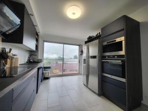 A kitchen or kitchenette at Homestay - Large Room in a Spacious Apartment with Stunning Rooftop Terrace