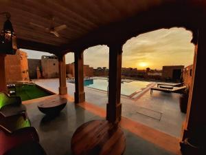 a balcony with a view of a swimming pool at The Mama's Resort & Camp in Kūri