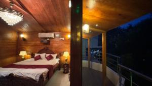 a bedroom with a bed and a balcony at MOHI VILLA in Puducherry