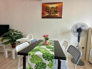 a dining room with a table and chairs and a fan at CEO9 Duplex Premier Suite #2-7Pax#Disneys HS #PISA #USM #Pantai Hospital in Bayan Lepas