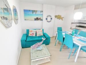 a living room with a blue couch and a table at Apartamento 802 Brisas marinas Santa Marta COLOMBIA in Santa Marta
