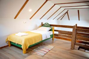 - une chambre avec un lit dans une pièce dotée de poutres dans l'établissement Due Fratelli Village Resort, à Şinteu