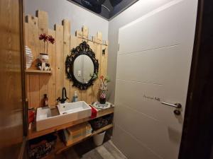 a bathroom with a sink and a mirror at O centre in Saint-Avold