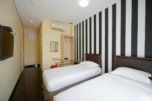 Rúm í herbergi á Multi 88 Syariah