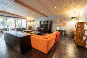 聖彼得的住宿－Villa LAtibulum，客厅配有橙色沙发和电视