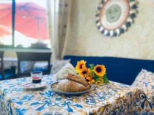 a table with a plate of bread and a glass of wine at La Cascina Camere in Agerola