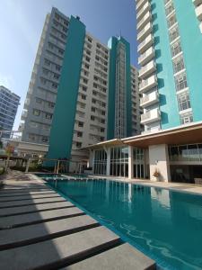 a swimming pool in front of some tall buildings at Mesavirre Garden Residences in Bantud Hacienda