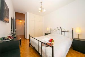 a bedroom with a bed with a bowl of fruit on it at Pool House - Happy Rentals in Lugano