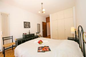 a bedroom with a bed with a book and flowers on it at Pool House - Happy Rentals in Lugano