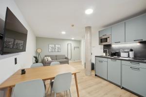 a kitchen and living room with a table and chairs at limehome Nuremberg Celtisplatz in Nuremberg