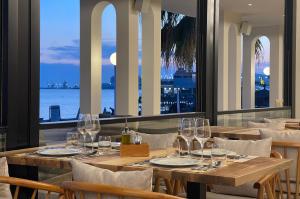 a table in a restaurant with a view of the ocean at Volmar Hotel in Durrës