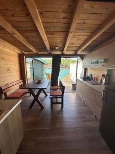 a kitchen with a wooden ceiling and a table at Tiny House Ada Bojana in Ulcinj