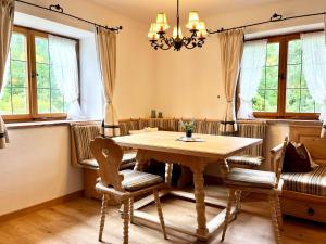 a dining room with a wooden table and chairs at Ferienhaus Anni in Kreuth +12 photos