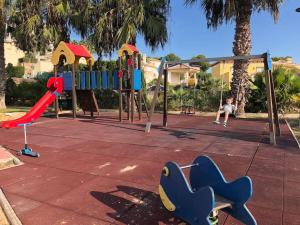a child playing on a playground in a park at La casa de Lucas in Orihuela Costa