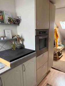 a kitchen with a stove and a counter top at Cozy City apartment in Holbæk