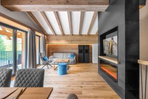 a living room with a fireplace in a house at Lech Valley Lodge in Warth am Arlberg