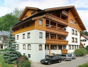 a large building with cars parked in front of it at Familienhotel Steindl in Millstatt