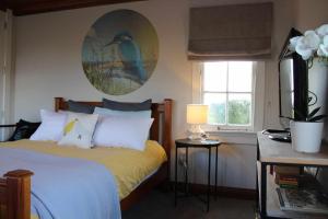 a bedroom with a bed and a window at The Studio - Huntly House in Auckland