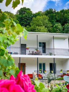 a white building with flowers in front of it at White House In Borjomi in Borjomi