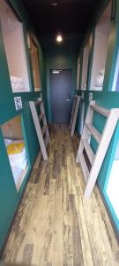 a room with four bunk beds and a door at Wasabi Mita Hotel in Tokyo