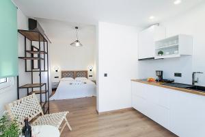 a kitchen and living room with a bed in the background at Georgia apartments in town in Skiathos Town