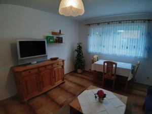 a living room with a television and a table at Ferienapartment Karle in Nordrach